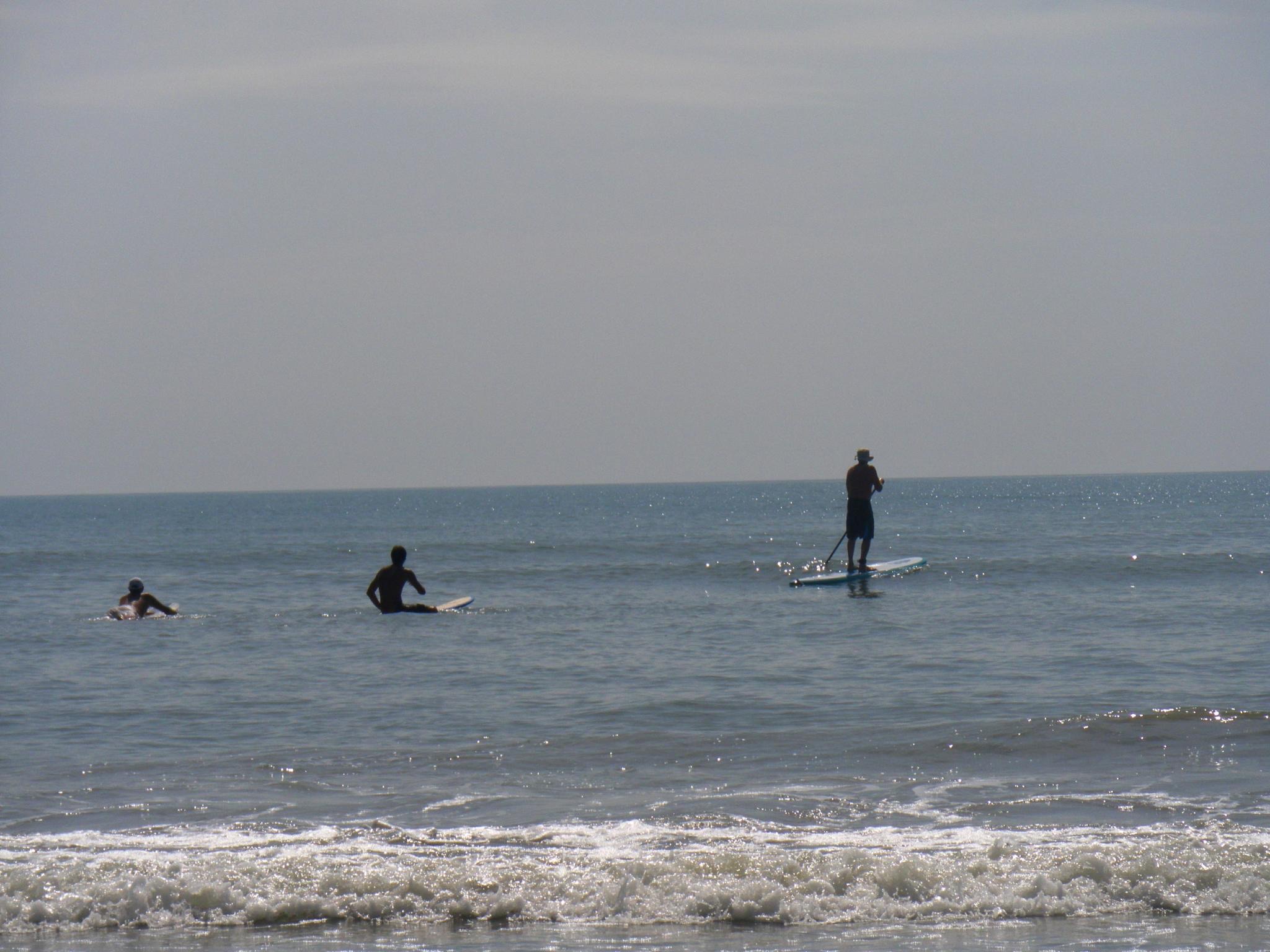 A person stand-up paddleboarding on the water off Cocoa Beach