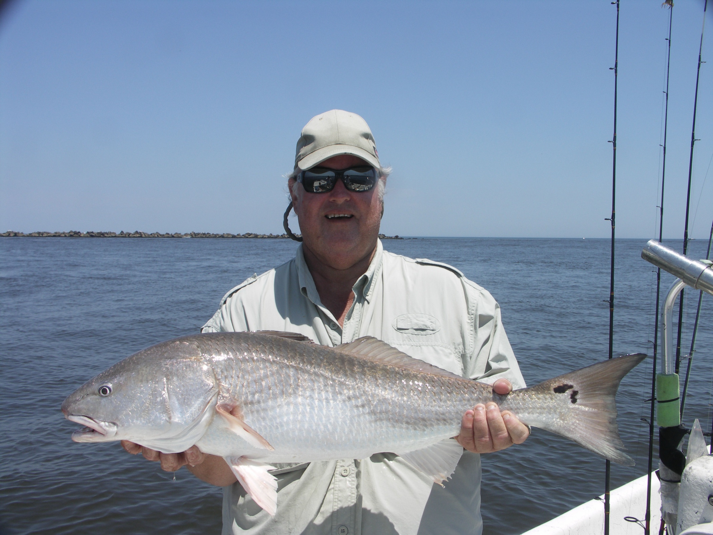 An angler holding a redfish caught on the inshore flats near Jacksonville, Florida